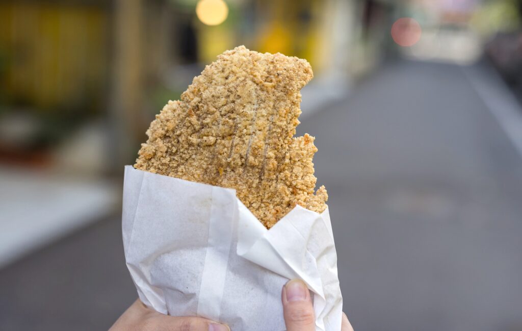 小町通りで食べ歩きする揚げたてのメンチカツ